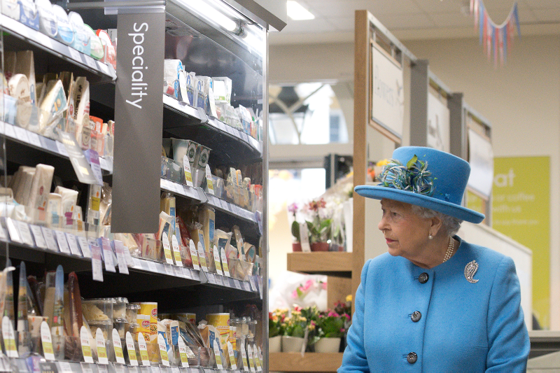 Queen Elizabeth II looks at products on the shelves at a Waitrose supermarket during a visit to the town of Poundbury on October 27, 2016 in Poundbury, Dorset. Photo via Getty Images.Â